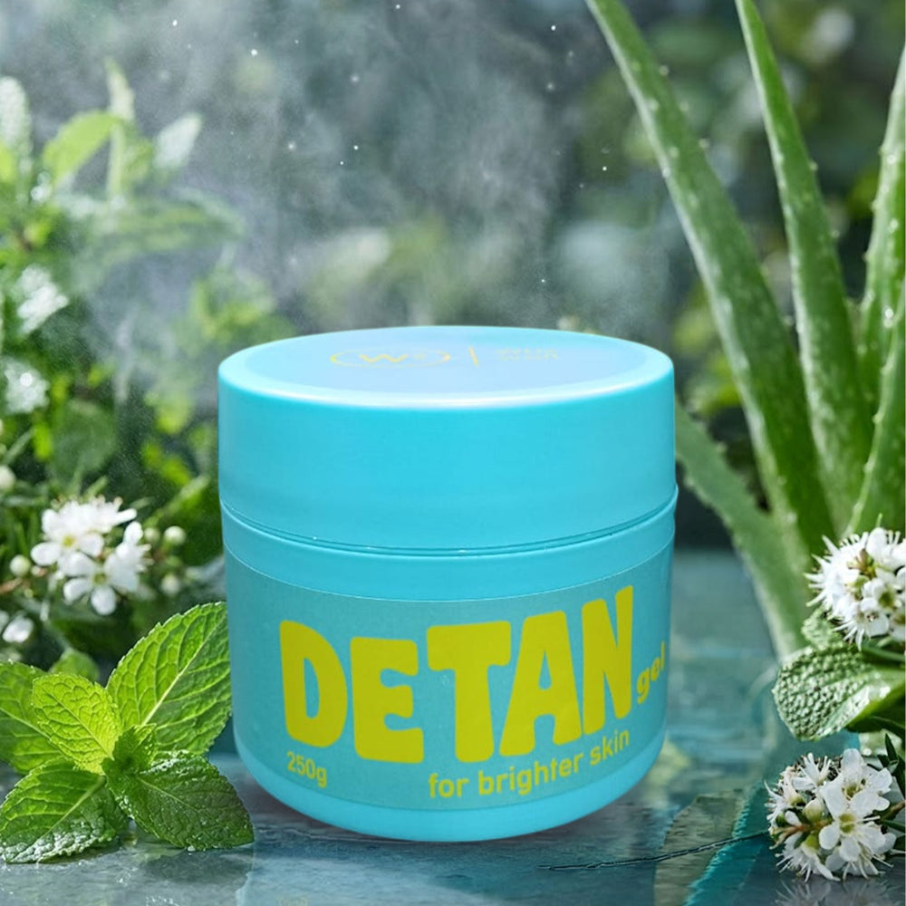 Blue jar labeled 'DETAN' with greenery in the background
