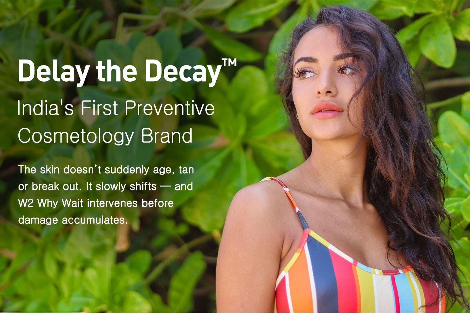 Woman in a colorful dress with text about 'Delay the Decay' cosmetic brand against a green leafy background